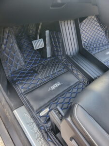Custom leather floor mats installed in Tesla Cybertruck front seat